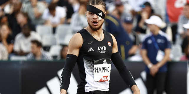 France's Wilfried Happio wears a bandage after being assaulted at the warm-up stage during in the mens 400 metre hurdles final during the French Elite Athletics Championships at the Helitas stadium in Caen, northern France, on June 25, 2022.