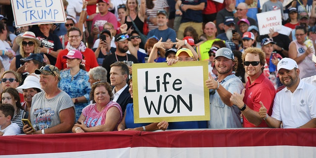 Supporters display signs recognizing the overthrow of Roe v. Wade during a Save America Rally with former United States President Donald Trump at the Adams County Fairgrounds on June 25, 2022 in Mendon, Illinois.  (Photo by Michael B. Thomas/Getty Images)