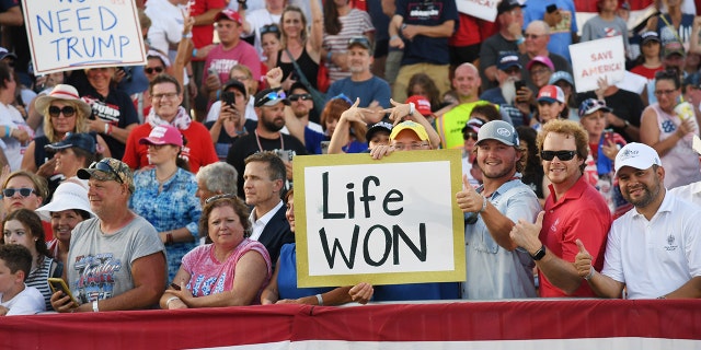 Supporters display signs recognizing the overturn of Roe v. Wade during a Save America Rally with former US President Donald Trump at the Adams County Fairgrounds on June 25, 2022 in Mendon, Illinois. (Photo by Michael B. Thomas/Getty Images)