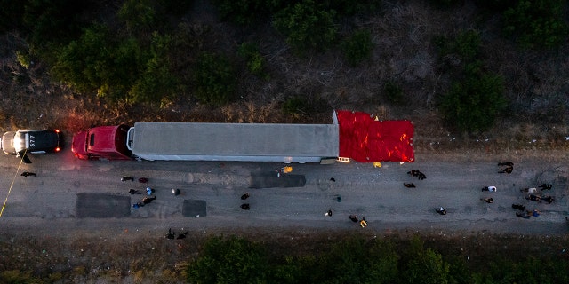 In this aerial view, members of law enforcement investigate a tractor trailer on June 27, 2022 in San Antonio, Texas. 