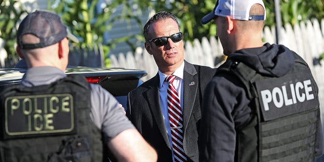 Todd Lyons, ICE acting field office director, talks with his agents after they made three arrests on Sept. 25, 2019, in Revere, Massachusetts.