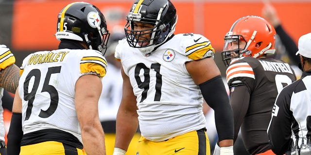 Chris Wormley (95) and Stephon Tuitt (91) of the Pittsburgh Steelers react after Wormley's sack against Baker Mayfield (6) of the Cleveland Browns in the second quarter at FirstEnergy Stadium Jan. 3, 2021, in Cleveland.