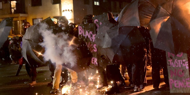 Demonstrators protesting the shooting death of Daunte Wright face off with police near the Brooklyn Center police station on April 13, 2021 in Brooklyn Center, Minnesota.