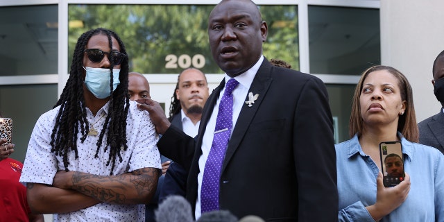 Benjamin Crump, one of the lawyers representing the family of Andrew Brown Jr., stands with Mr. Brown's son Khalil Ferebee as he speaks during a press conference on April 27, 2021, in Elizabeth City, North Carolina. 