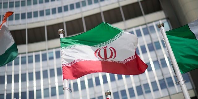 FILE: The flag of Iran is seen in front of the building of the International Atomic Energy Agency (IAEA) Headquarters ahead of a press conference by Rafael Grossi, Director General of the IAEA, about the agency's monitoring of Iran's nuclear energy program on May 24, 2021, in Vienna, Austria. 