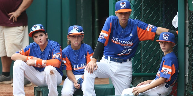 WILLIAMSPORT, PA - AUGUST 29: Michigan players sit outside the dugout prior to their 2021 Junior World Championship game against the Ohio team at Howard G. Lamade Stadium on August 29, 2021, in Williamsport, Pennsylvania. 