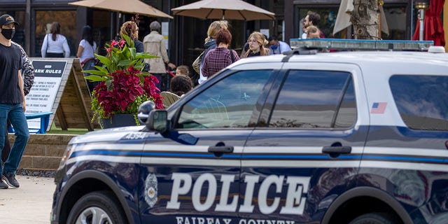 This file photos shows a Fairfax County Police car parked outside as people visit Mosaic Shopping Center Mall on Oct. 30, 2021, in Fairfax, Virginia. 