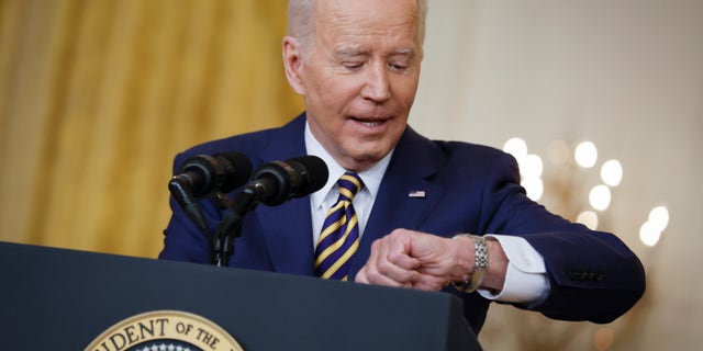 WASHINGTON, DC - JANUARY 19: U.S. President Joe Biden checks his watch while answering questions during a news conference in the East Room of the White House on January 19, 2022 in Washington, DC. With his approval rating hovering around 42-percent, Biden is approaching the end of his first year in the Oval Office with inflation rising, COVID-19 surging and his legislative agenda stalled on Capitol Hill. (Photo by Chip Somodevilla/Getty Images)