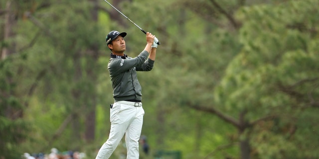 Kevin Na plays his shot on the 14th hole during the second round of the Masters at Augusta National Golf Club April 8, 2022, in Augusta, Ga.