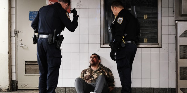 Police detain a man at a Times Square subway station following a call to police from riders on April 25, 2022, in New York City.