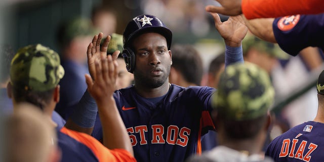 Yordan Alvarez #44 of Houston Astros teammates after being double-headed by Yuli Gurriel #10 in the fifth inning against the Texas Rangers at Minute Maid Park on May 22, 2022 in Houston, Texas.