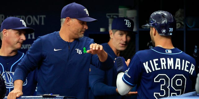 Kevin Kiermaier #39 of the Tampa Bay Rays is congratulated after scoring a run by manager Kevin Cash #16 in the first inning during a game against the Miami Marlins at Tropicana Field on May 25, 2022 in St Petersburg, Florida. 