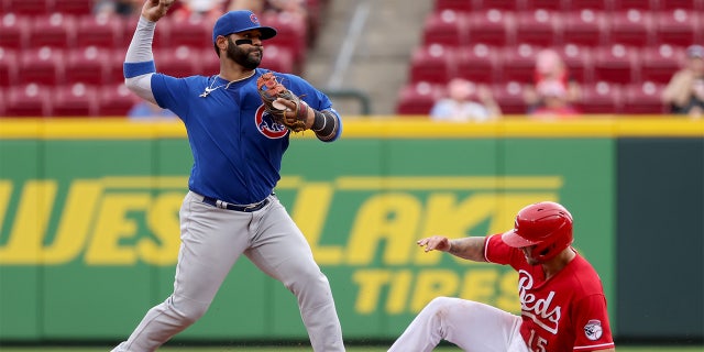 CINCINNATI, OHIO - MAY 26: Jonathan Villar #24 of the Chicago Cubs attempts to turn a double play past Nick Senzel #15 of the Cincinnati Reds in the seventh inning at Great American Ball Park on May 26, 2022 in Cincinnati, Ohio.