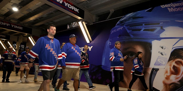 New York Rangers fans walk to the arena prior to Game 1 between the Tampa Bay Lightning and the New York Rangers in the Eastern Conference finals of the 2022 Stanley Cup playoffs at Madison Square Garden June 1, 2022, in New York City. 