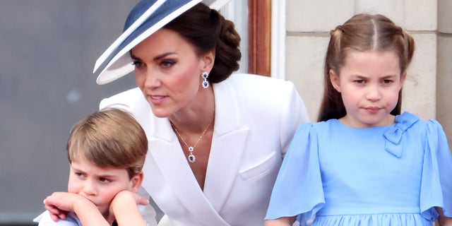 Prince Louis of Cambridge, Catherine, Duchess of Cambridge and Princess Charlotte of Cambridge on the balcony of Buckingham Palace.