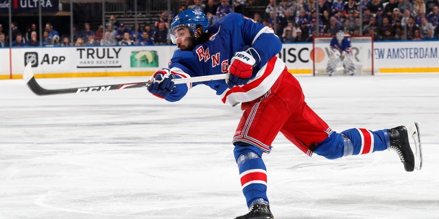 Mika Zibanejad (93) of the New York Rangers shoots the puck against the Tampa Bay Lightning in Game 1 of the Eastern Conference finals of the 2022 Stanley Cup Playoffs at Madison Square Garden June 1, 2022, in New York City.