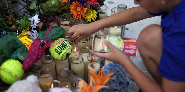 Brad Fowler of San Antonio, Texas, lights up candles at a memorial dedicated to the victims of the mass shooting at Robb Elementary School on June 3, 2022 in Uvalde, Texas. 