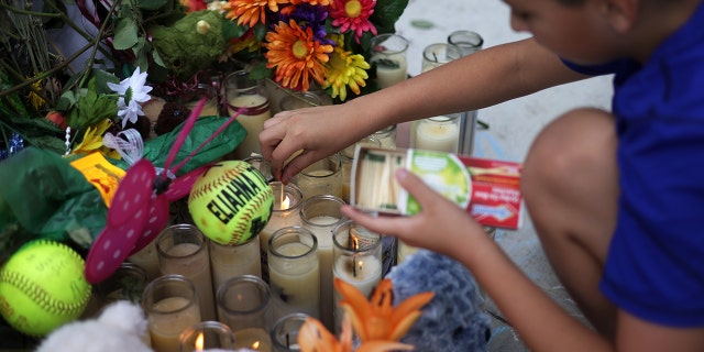 Brad Fowler of San Antonio, Texas, lights up candles at a memorial dedicated to the victims of the mass shooting at Robb Elementary School on June 3, 2022 in Uvalde, Texas. 