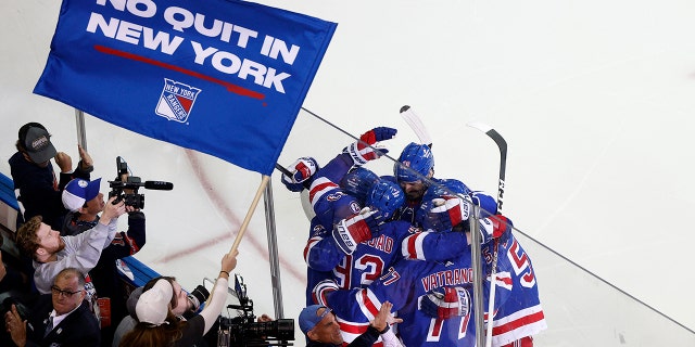 Mika Zibanejad (93) of the New York Rangers celebrates with teammates after scoring a third-period goal against the Tampa Bay Lightning in Game 2 of the Eastern Conference finals at Madison Square Garden June 3, 2022, in New York City.