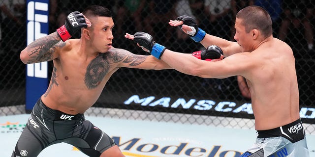 Jeff Molina, left, punches Zhalgas Zhumagulov of Kazakhstan in a flyweight fight during UFC Fight Night at UFC APEX June 4, 2022, in Las Vegas.