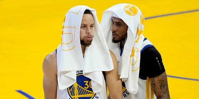 Stephen Curry, left, and Gary Payton II of the Golden State Warriors celebrate after defeating the Boston Celtics in Game 2 of the 2022 NBA Finals at Chase Center June 5, 2022, in San Francisco. 