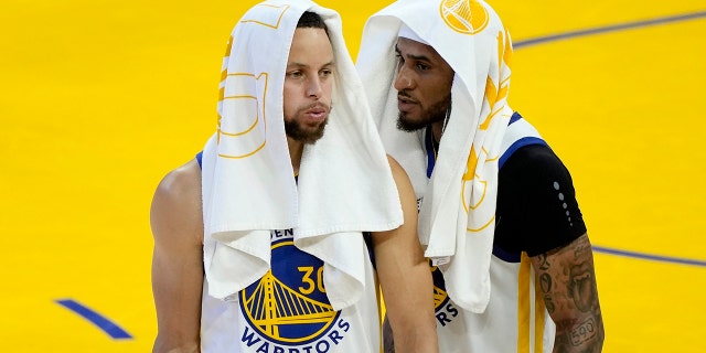 Stephen Curry, left, and Gary Payton II of the Golden State Warriors celebrate after defeating the Boston Celtics in Game 2 of the 2022 NBA Finals at Chase Center June 5, 2022, in San Francisco. 