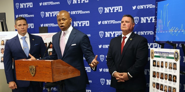 New York Mayor Eric Adams is joined by NYPD Deputy Chief Jason Savino (left) and NYPD Chief of Detectives James Essig at a Brooklyn police facility for a press conference featuring mug shots of dozens of gang members taken off the streets amid a more aggressive policing strategy targeting gang violence. 