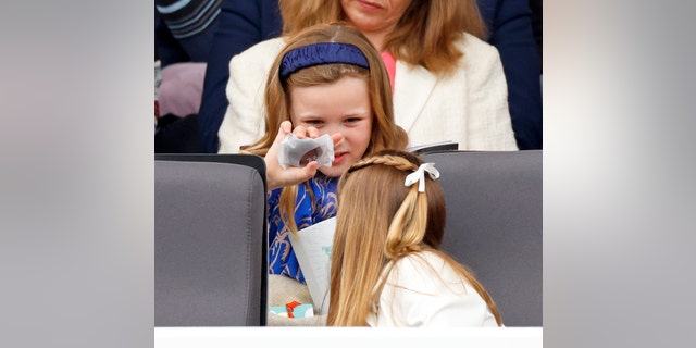 Mia Tindall and Princess Charlotte open their Fortnum &amp; Mason gift bags as they attend the Platinum Pageant.