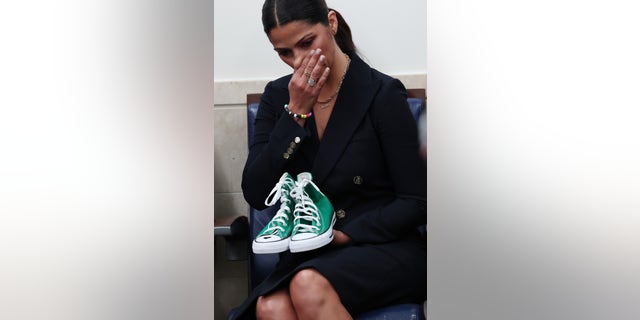 Camila Alves McConaughey holds a pair of shoes worn by one of the victims of the school shooting in Uvalde, Texas, during the press briefing at the White House.