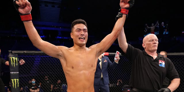 Zhang Mingyang of China reacts after his knockout over Tuco Tokkos of England during the Road to UFC event at Singapore Indoor Stadium on June 09, 2022 in Singapore.
