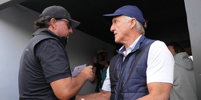 Greg Norman talks to Phil Mickelson during the LIV Golf Invitational on June 9, 2022 in St. Albans, England.