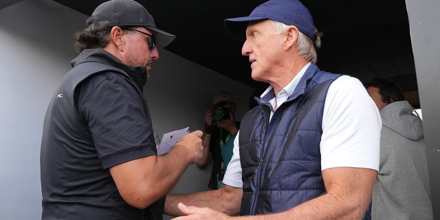 Greg Norman talks to Phil Mickelson during the LIV Golf Invitational on June 9, 2022 in St. Albans, England.