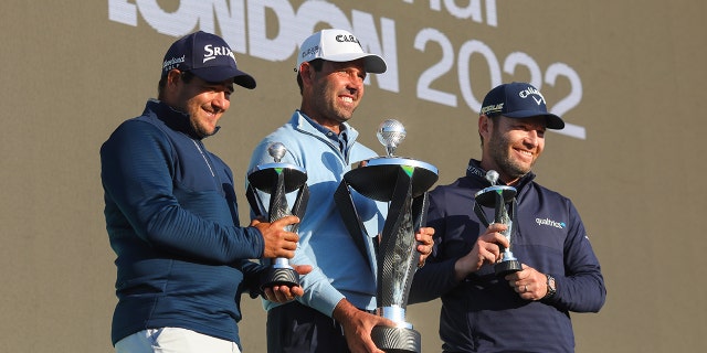 Charl Schwartzel of Stinger GC celebrates with the LIV Golf Invitational Individual trophy alongside teammates Hennie du Plessis (L) and Branden Grace (R) who hold their runner's up trophies during day three of LIV Golf Invitational - London at The Centurion Club on June 11, 2022 in St Albans, England.