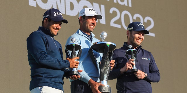 Charl Schwartzel of Stinger GC celebrates with the LIV Golf Invitational Individual trophy alongside teammates Hennie du Plessis (L) and Branden Grace (R) who hold their runner's up trophies during day three of LIV Golf Invitational - London at The Centurion Club on June 11, 2022 in St Albans, England. 