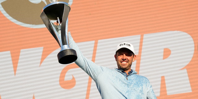 Charl Schwartzel of Stinger GC celebrates with the LIV Golf Invitational individual trophy following victory during day three of LIV Golf Invitational - London at The Centurion Club on June 11, 2022 in St Albans, England. 