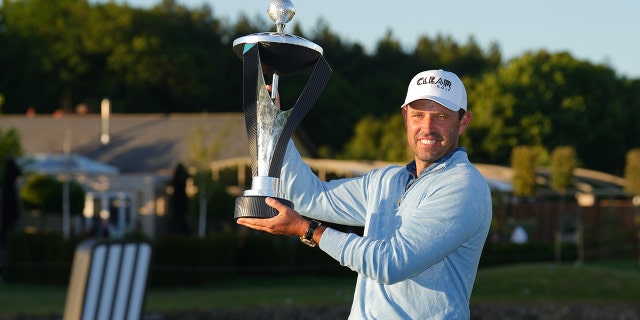 Charl Schwartzel of Stinger GC celebrates with the LIV Golf Invitational individual trophy following his victory at the LIV Golf Invitational London at The Centurion Club June 11, 2022, in St. Albans, England.