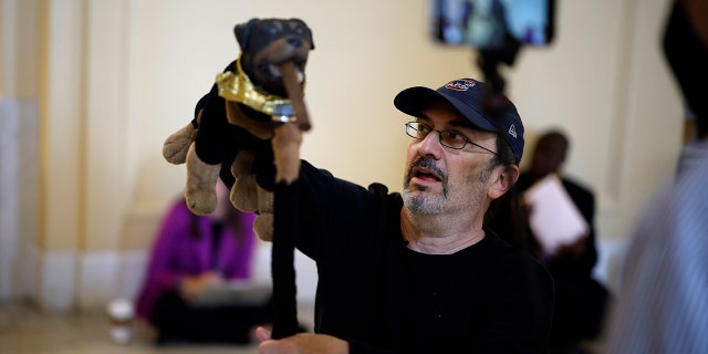 Actor and comedian Robert Smigel performs as Triumph the Insult Comic Dog in the hallways outside the House Select Committee to Investigate the January 6th Attack on the U.S. Capitol hearing in the Cannon House Office Building on June 16, 2022 in Washington, DC.