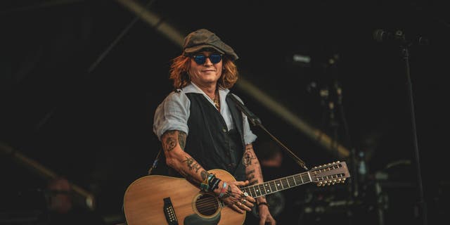 Johnny Depp performs on stage with Jeff Beck (not pictured) during the Helsinki Blues Festival at Kaisaniemen Puisto on June 19, 2022 in Helsinki, Finland.