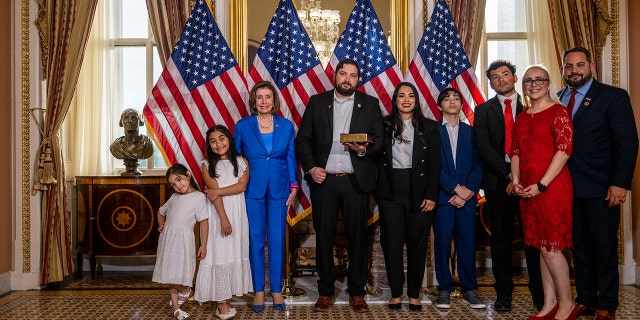 Washington DC-June 21: Parliamentarian-elect Myra Flores (R-TX) joins her family and Speaker of the House Nancy Pelosi (D-CA) after sworn in Washington DC on June 21, 2022. Standing  ..  (Photo by Brandon Bell / Getty Images)