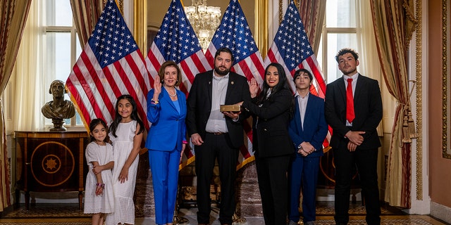 Rep. Mayra Flores poses with her family and House Speaker Nancy Pelosi after being sworn in on June 21, 2022, in Washington. 