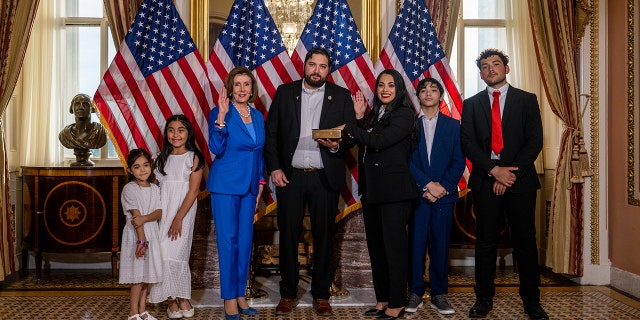 Rep. Mayra Flores poses with her family and House Speaker Nancy Pelosi after being sworn in on June 21, 2022, in Washington. 