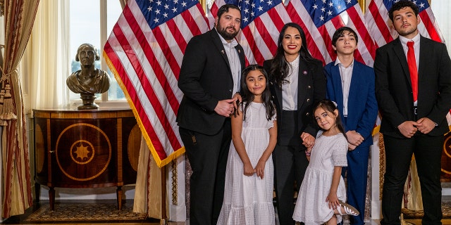 Congresswoman Mayra Flores stands with her family after being sworn in by House Speaker Nancy Pelosi on June 21, 2022, in Washington.