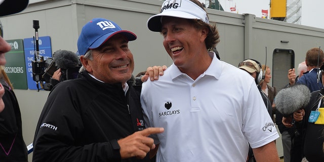 Phil Mickelson of the United States is congratulated by Fred Couples of the United States after winning the final round of the 142nd Open Championship at Muirfield on July 21, 2013 in Gullane, Scotland.