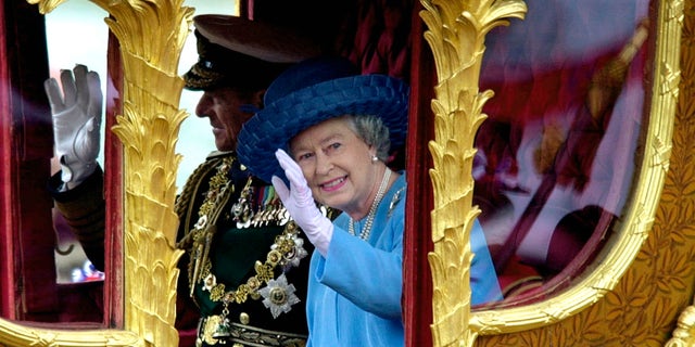 Queen Elizabeth with Prince Philip in the Gold State Coach during the procession from Buckingham Palace to St. Paul's Cathedral.