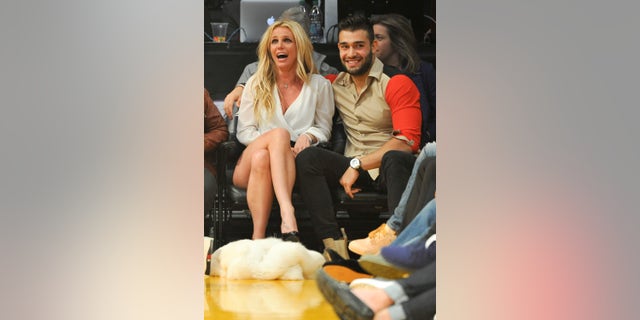 Britney Spears and Sam Asghari wore custom Versace looks during their wedding night.