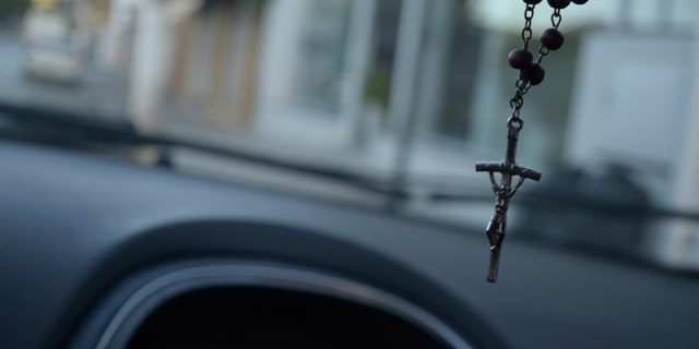 Close-up of a crucifix hanging in a car