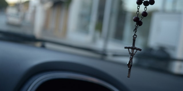 Close-up of a crucifix hanging in a car