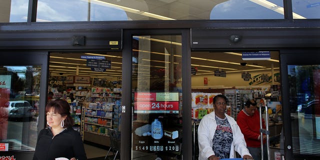 HOMESTEAD, FL- FEBRUARY 17:  Customers walk out of a Walgreens store on February 17, 2010 in Homestead, Florida. Today, Walgreen Co. announced plans to buy another drug store company, Duane Reade, for $618 million in cash.  (Photo by Joe Raedle/Getty Images)