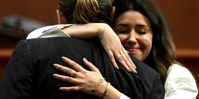 Attorney Camille Vasquez embraces Johnny Depp in the courtroom at the Fairfax County Circuit Courthouse in Virginia, on May 17, 2022.