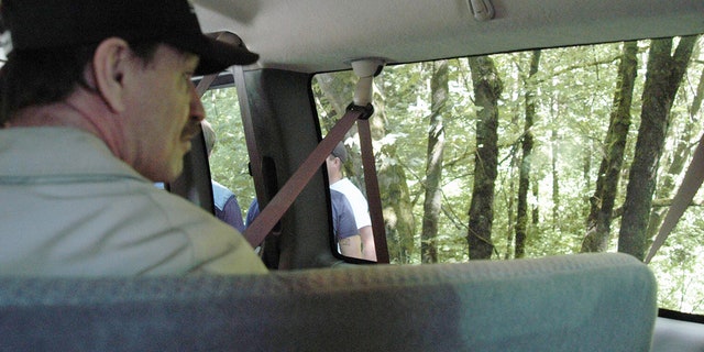 In this undated King County Prosecutor's Office handout photo, Green River killer Gary Leon Ridgway is seen as he takes investigators to one of the sights where he said he allegedly buried one of his victims. On November 5, 2003, in Seattle, Washington, Ridgway plead guilty to 48 murders dating back more than 20 years. In 2011, Ridgway pled guilty to the 1982 murder of his 49th victim, 20-year-old Rebecca Marrero.